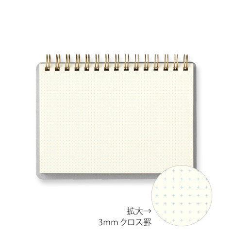 Small notebook with grid pattern on white background