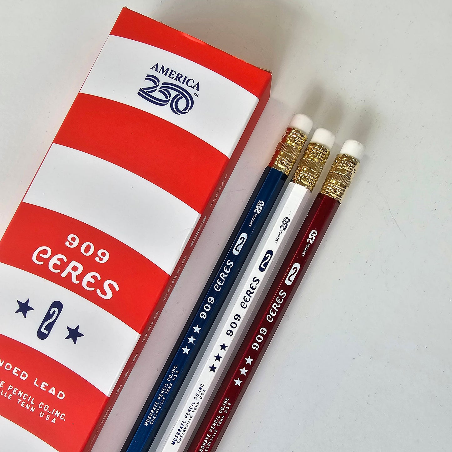Three CERES pencils with a red and white box on a light gray background